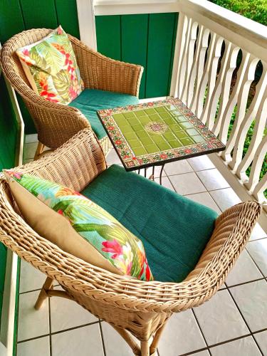 a wicker chair and a table on a porch at Big Island Retreat - No Resort Fees in Kailua-Kona