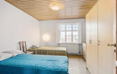 a bedroom with two beds and a window at 2 Bedroom Beautiful Home In Rudkbing in Rudkøbing