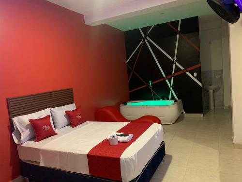 a bedroom with a bed and a bath tub at Hotel picasso in Piura