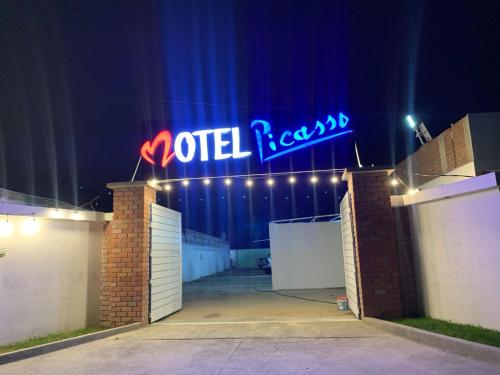 a sign that reads wild records is lit up at night at Hotel picasso in Piura