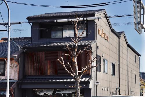 a building with a tree in front of it at THE ROOT2 HOTEL in Kyoto