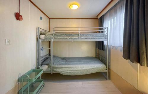 a small room with bunk beds in a room at Cozy stacaravan In Reutum With Wifi in Reutum