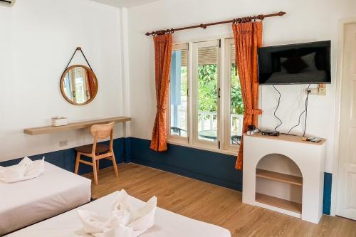 a living room with a bed and a fireplace at House No.2 Village in Krabi town