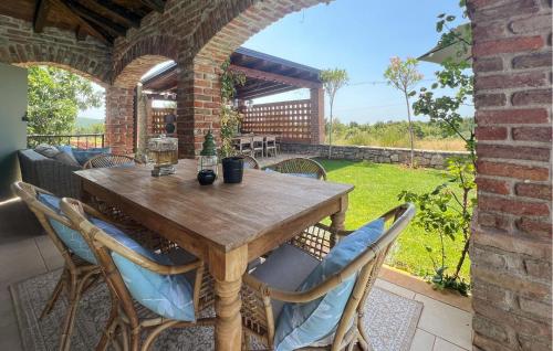 a wooden table and chairs on a patio at Villa Montona in Višnjan