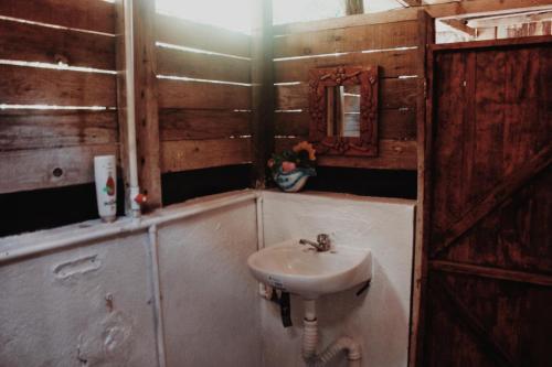 a bathroom with a sink and a mirror at Garden Cabins in Zipolite