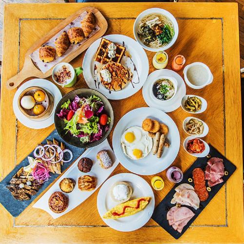 a wooden table with plates of food on it at DoubleTree by Hilton Shanghai Pudong - Present welcome cookie in Shanghai