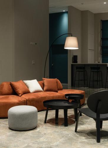 a living room with a couch and tables at Hotel Euphemia in Taichung