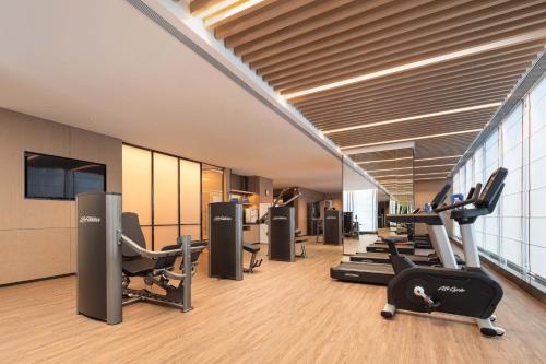 a gym with several treadmills and cardio machines at Crowne Plaza Jinan Runhua by IHG in Jinan