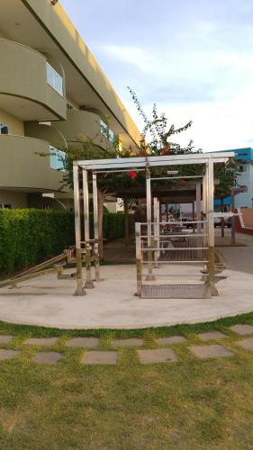 a bus stop in front of a building at Golden Lake Apart Hotel Arraial do Cabo RJ A&J 2 in Arraial do Cabo
