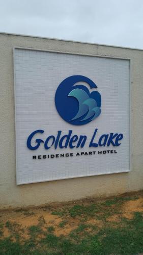 a sign on the side of a building at Golden Lake Apart Hotel Arraial do Cabo RJ A&J 2 in Arraial do Cabo