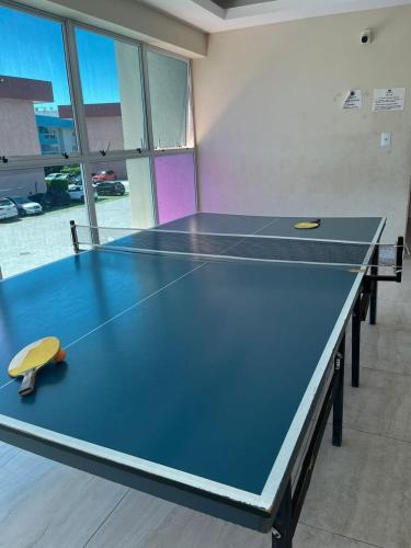 a ping pong table in a room with at Golden Lake Apart Hotel Arraial do Cabo RJ A&J 2 in Arraial do Cabo