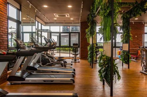 a gym with rows of treadmills and potted plants at Le Pavilion Bandar Puteri Puchong in Puchong