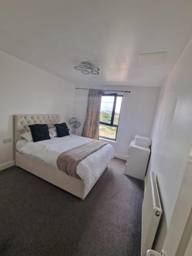 a bedroom with a large bed and a window at R apartment in London