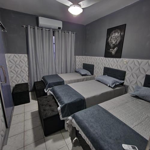 a bedroom with three beds in a room at Hostel Inn Gileade in Belém