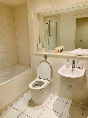 a bathroom with a toilet and a sink at R apartment in London