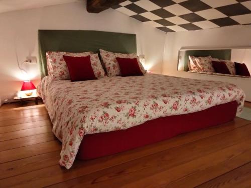 a bedroom with a large bed with red pillows at Spirit in the sky, a tiny house on the hills in Zago