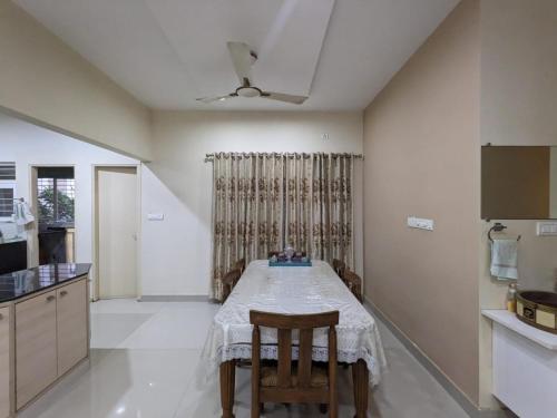 a kitchen with a table and chairs in a room at Soul House_4.5 BHK Apartment in Ahmedabad