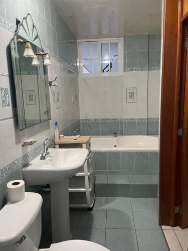 a bathroom with a sink and a toilet and a tub at Departamentos grandes y centricos. in Poza Rica de Hidalgo
