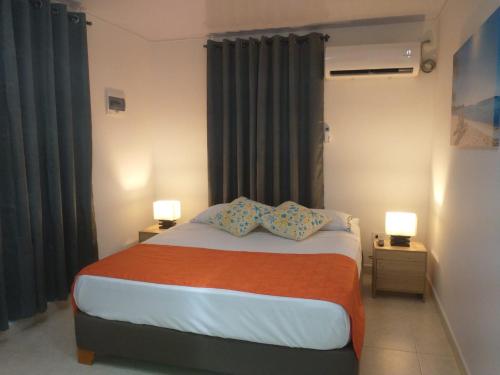 ein Schlafzimmer mit einem Bett mit zwei Kissen darauf in der Unterkunft Ketlina Village in Providencia