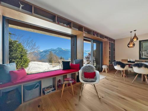 a living room with a large window with a view at Mirador Lodge - Crans Montana - Swiss Alps in Crans-Montana