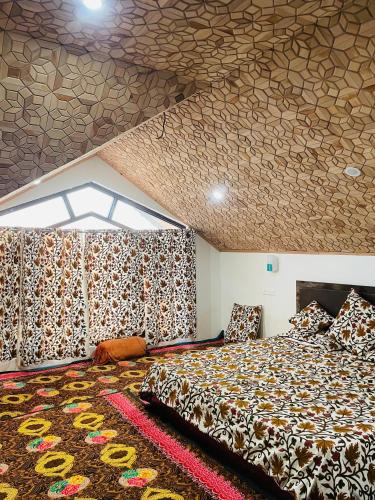 a bedroom with a bed and a patterned ceiling at Serenity canopy in Srinagar