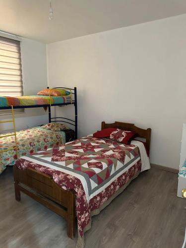 a bedroom with two bunk beds in a room at Casa cómoda, grande y agradable. in Arica