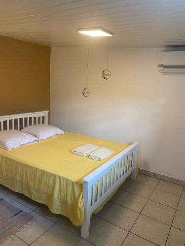 a bedroom with a large bed with towels on it at T2 calme à Remire-Montjoly in Rémire-Camp