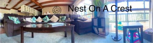 a living room with a couch and a table at Nest On A Crest in Rye