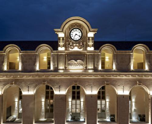 a building with a clock on the top of it at InterContinental Marseille - Hotel Dieu by IHG in Marseille