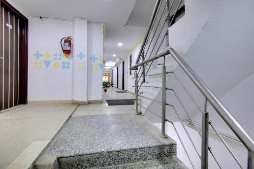 a hallway with stairs in a building at Flagship Khanpur STAY in New Delhi