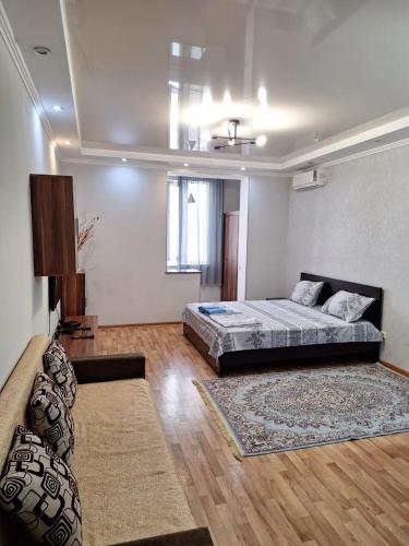 a large room with a bed and a couch at ЖК Сункар in Almaty