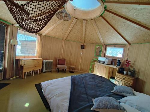 a bedroom in a yurt with a bed and a desk at Auberge du Col du Festre in Le Dévoluy