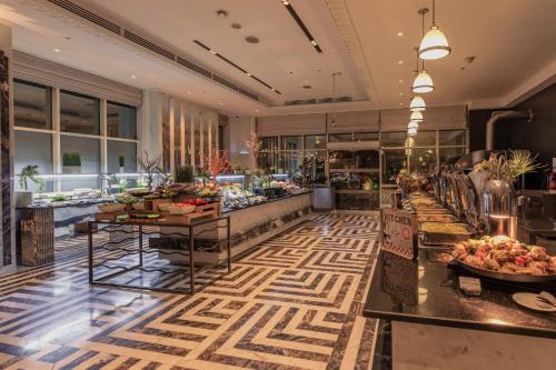 a lobby of a hotel with a buffet at Stella Di Mare Dubai Marina Hotel in Dubai