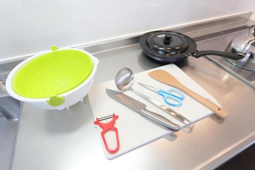 a kitchen counter with a green bowl and scissors at Sungarden - Vacation STAY 95967 in Otaru