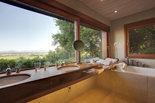 a bathroom with two sinks and a large window at Clos Apalta Residence Relais & Chateaux in Santa Cruz