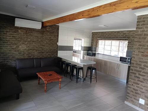a kitchen with a couch and a table in a room at The View on Vaal Resort in Sasolburg