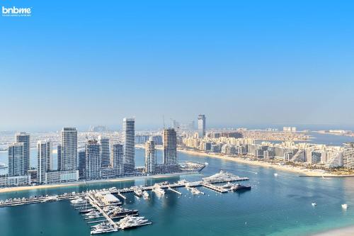 an aerial view of a city with boats in the water at bnbmehomes - Ocean Heights in Dubai