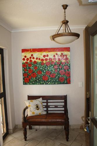 a bench in a room with a painting on the wall at Erf Three Seven Eight Langstrand Self-Catering in Langstrand
