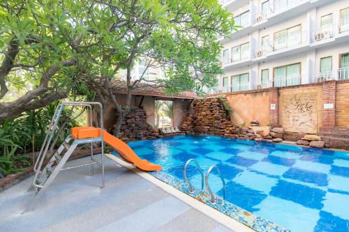 an outdoor swimming pool with a slide and a playground at Bella Villa Prima in Pattaya