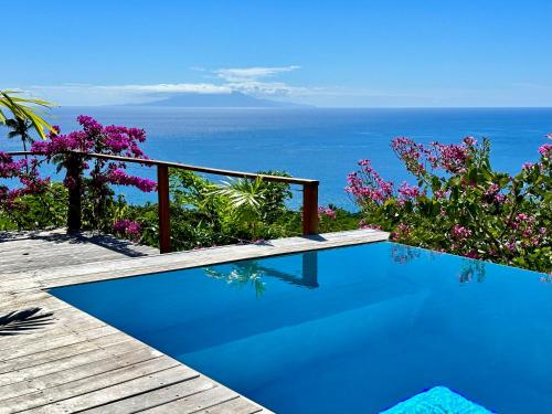 a swimming pool with a view of the ocean at Infinity Luxury Villa - Stunning Sea and Piton Views in Soufrière