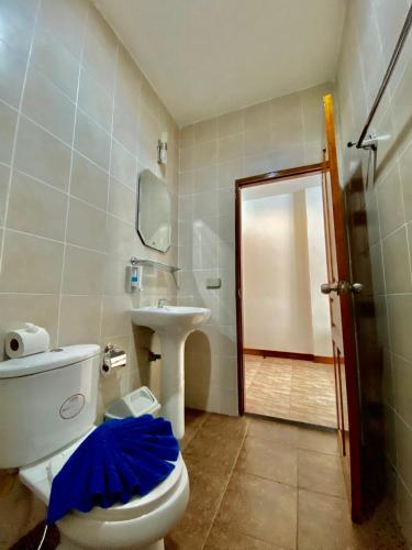 a bathroom with a toilet and a sink and a mirror at BT hotel Kata Beach in Kata Beach