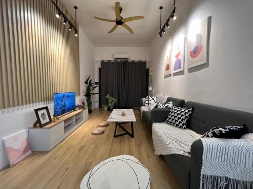 a living room with a couch and a table at DeMUJI 4BR 10PAX 3Min to ECM KCM, PS4 in Kuantan
