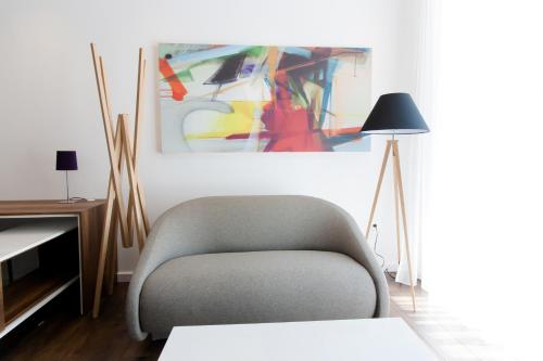 a living room with a chair and a lamp at Perla Luxury in Ulcinj