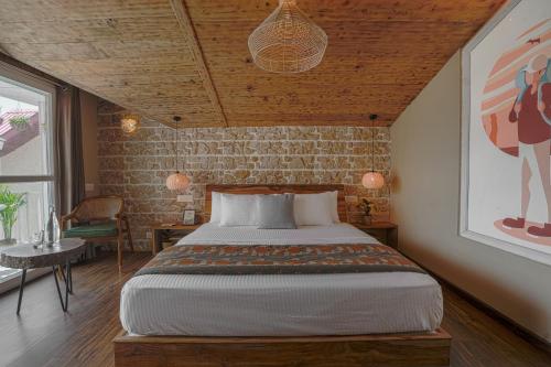 a bedroom with a bed and a brick wall at Saanjh - The Musical Sunset in Shimla