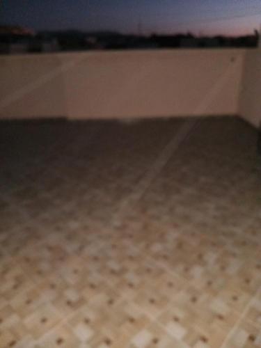 a room with a tile floor and a bed at Appt, Agréable Lumineux et ensoleillé in Agadir