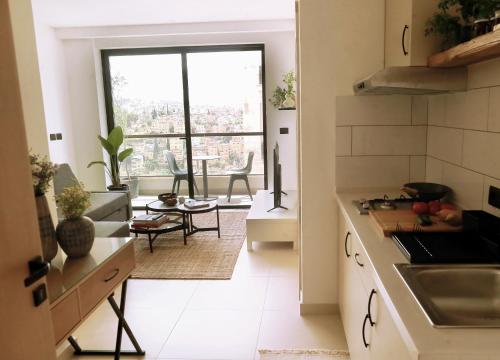 a kitchen with a large window and a table at Nu Fifty Two in Amman