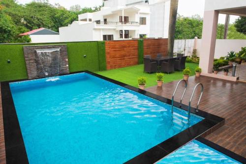 a swimming pool in the middle of a house at Ishara villa in Indore