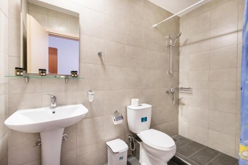 a bathroom with a toilet and a sink at Istira in Possidi