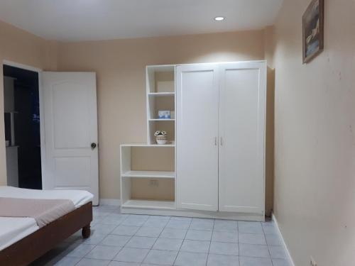 um quarto com uma cama e um armário branco em Lymen's Apartment em Cordova