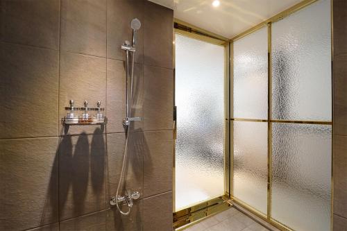 a shower with a glass door in a bathroom at Hotel Mar Samsan in Ulsan
